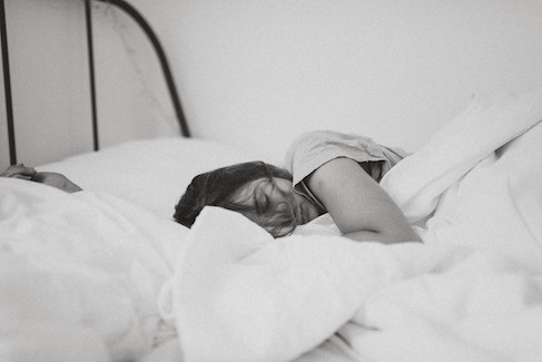 person resting head on pillow